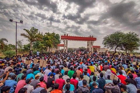 Hundreds of students sat on sit in protest at the entrance of the IIIT Basar campus.