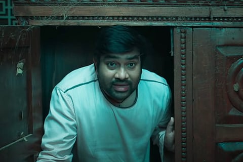 Shiva is seen peeking outside a door in the image.