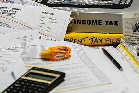 Representational image showing several papers and a calculator