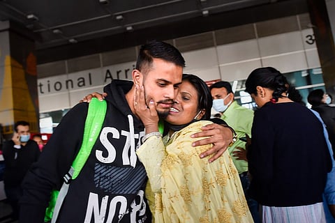 An Indian student returning from Ukraine being greeted by his family