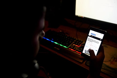 Man reading news on his phone after internet was restored in Jammu and Kashmir