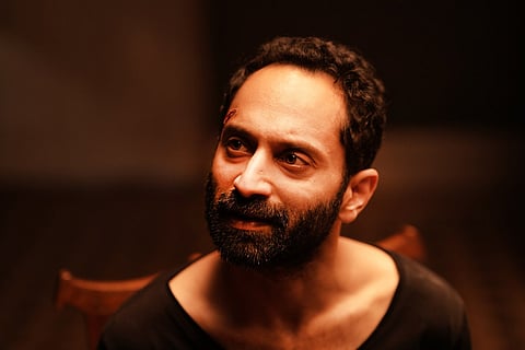 Fahadh in a black T shirt looking to the side in Irul