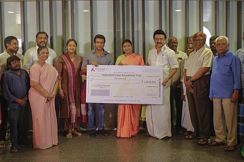 Suriya handing over the cheque to MK Stalin