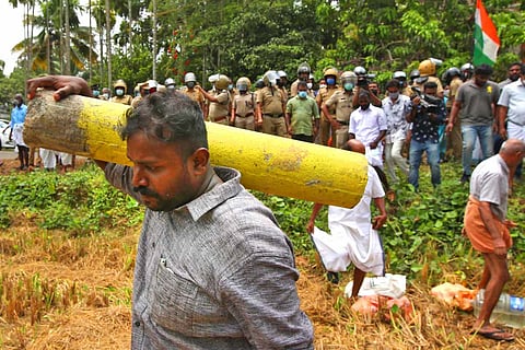 A man carrying a survey stone amid K-Rail protest in Kerala
