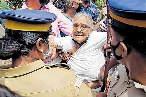An old woman being manhandled by the police