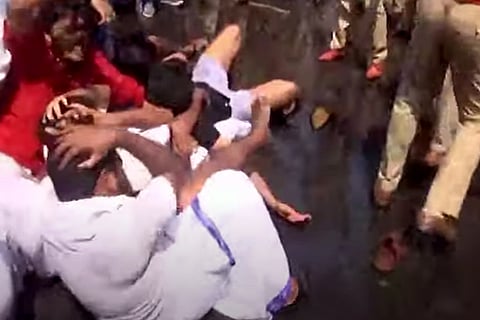 Kerala KSU Workers keeping hands on head during a clash with the police outside the Secretariat