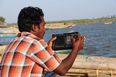 Fisherman listening to radio