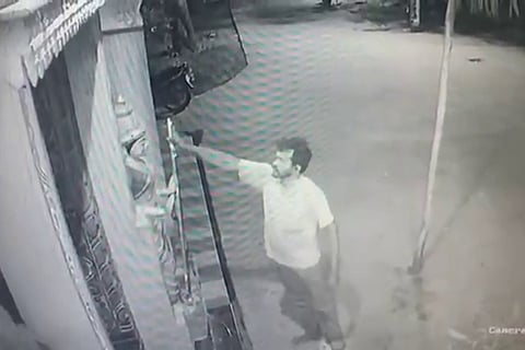 CCTV footage of a man holding an idol's trident in Kakinada