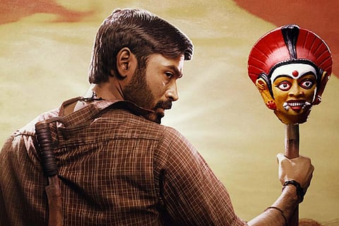 Dhanush as Karnan standing with a mask and with his back to the camera