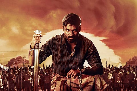 Dhanush with a sword and the sun in the background in Karnan