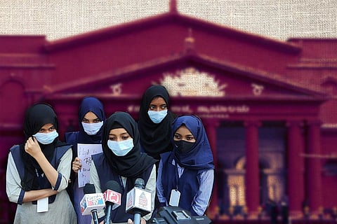 Muslim students wearing hijab in front of a picture of the Karnataka High Court