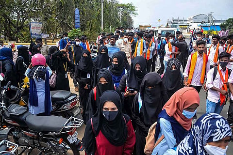 Chikmagalur: Students wearing saffron shawls stage a protest against allowance of hijab-wearing students to enter classrooms