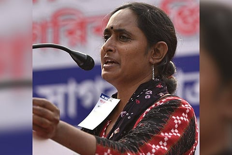 CPI(ML) leader Kavita Krishnan speaking into a mic