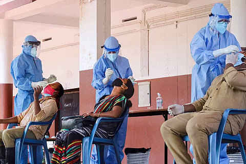 Health workers collecting samples from people to test COVID-19