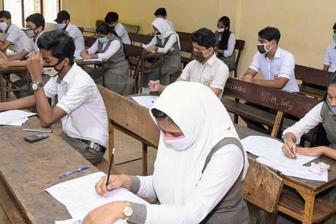 Students attending SSLC examination in Kerala during the pandemic time wearing masks and keeping physical distancing