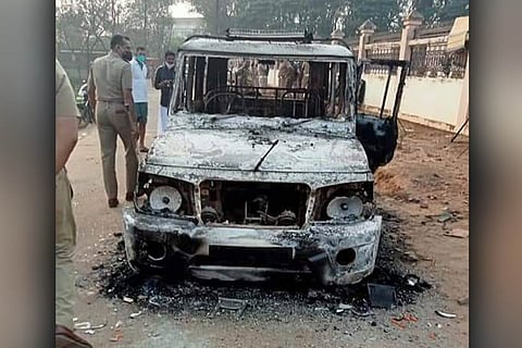 A police vehicle that was burnt by workers of the Kitex garments factory in Kerala