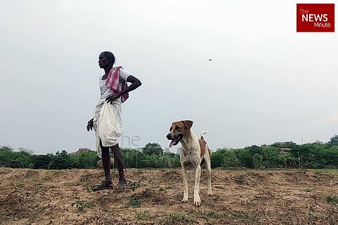 A farmer with his pet at his assigned land in Islampur village of Thoopran in Medak district