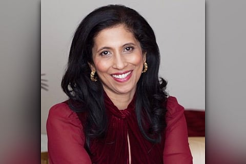 Leena Nair in a maroon shirt, smiling at the camera