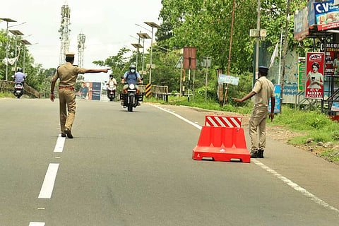 Two police officers regulating traffic on a road