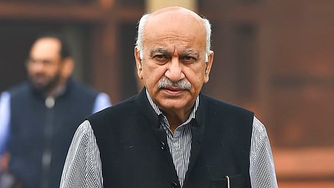 A photograph of MJ Akbar facing the camera, clad in a striped shirt and a waistcoat.