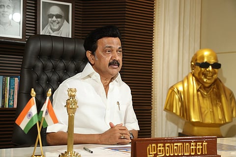 MK Stalin in his office with a golden bust of Karunanidhi on the side