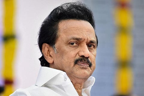 Tamil Nadu Chief Minister MK Stalin wearing a white shirt and looking right into the camera