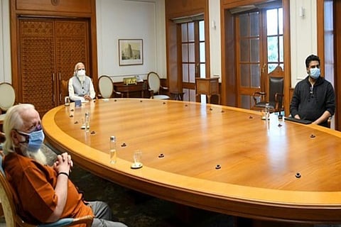 Actor Madhavan, Nambi Narayanan and PM Modi seen at a round table in a conference room.