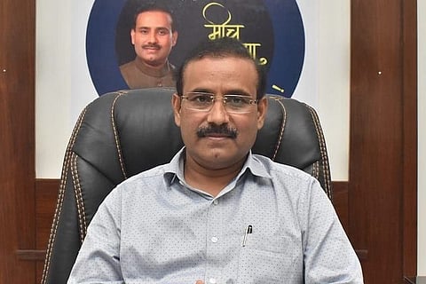 A file image of Maharashtra Health Minister Rajesh Tope sitting on a leather chair wearing a grey shirt and looking into camera