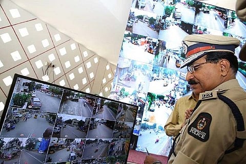 File photo of DGP Mahender Reddy looking at CCTV footage
