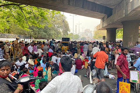 Several disabled persons gather under bridge