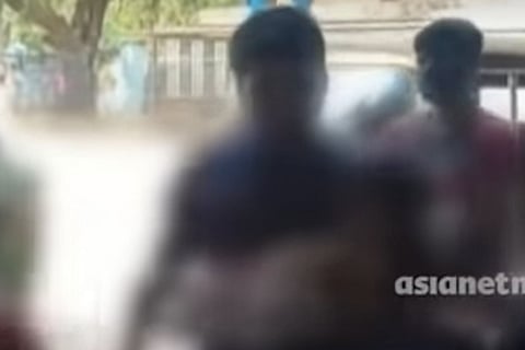 Man carrying one of the children who was starved and locked up in a room