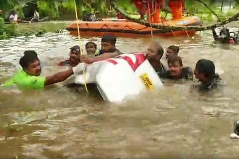 Rescue workers pulling out Justin's car