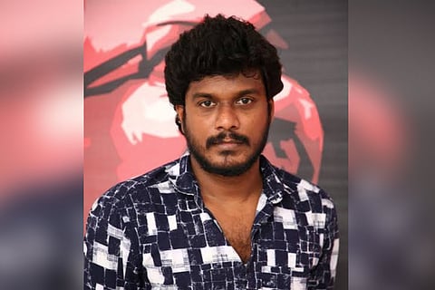 Actor Manikandan in black and white shirt