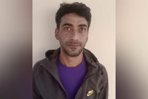 Meharaj-ul-Ashqeen Bhat wearing a dark blue t-shirt and a brown coat