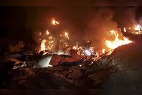 The rubbles of crashed MiG-21 aircraft burning