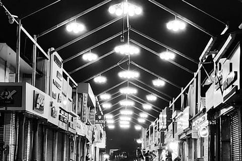 Black and white photo of SM Street in Kozhikode with lights on top