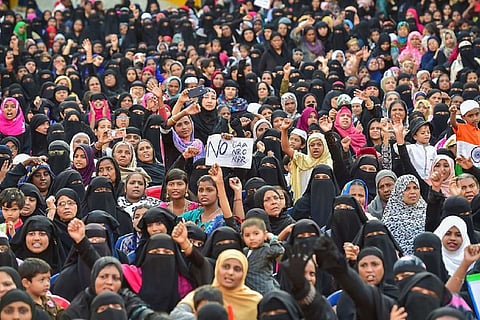 Muslim women hold placards and raise slogans during a protest against CAA, NRC, NPR in Bengaluru in January 2022