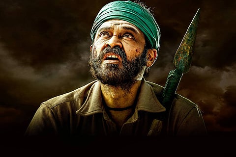 Venkatesh in green turban looking up at the sky