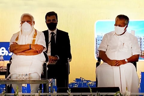 PM Modi with Kerala Chief Minister Pinarayi Vijayan, both wearing white mask, at a venue in Kochi, Kerala
