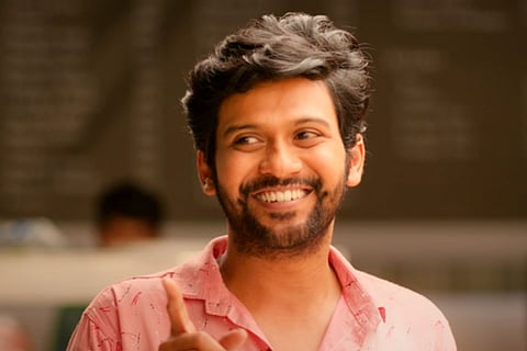 Naveen Polishetty in pink shirt and smiling in the movie Jathi Ratnalu