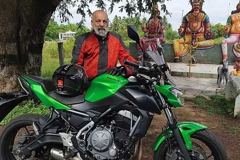 Navroze Contractor standing near a sports bike