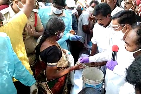 YSRCP MLA Kakani Govardhan Reddy and Bonigi Anandaiah distributing herbal preparations to COVID patients
