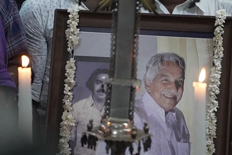 Framed images of Kerala leader Oommen Chandy during his youth and old age