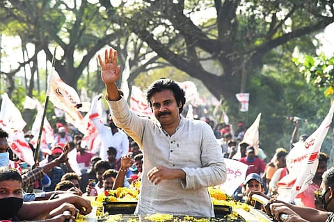 Pawan Kalyan waving to supporters from roof of a vehicle