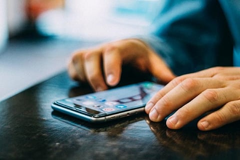 Representative image of a person on his phone