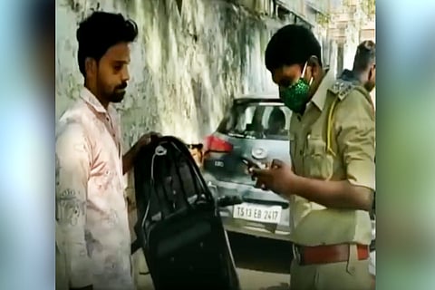 A cop checking the phone of a citizen in Hyderabad