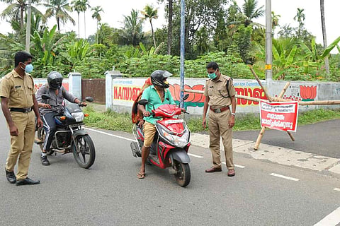 Police stopping a two wheeler to check e pass