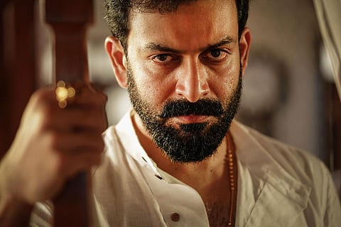 Prithviraj is seen donning a white shirt, striking an angry look.
