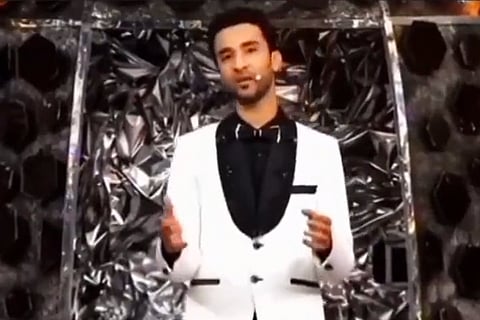 Raghav Juyal wearing a black and white outfit and anchoring Dance Deewane