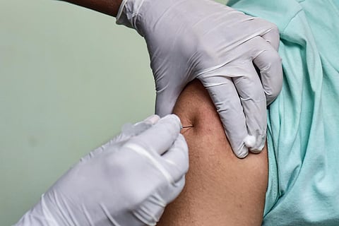 Image of a person being injected vaccine shot
